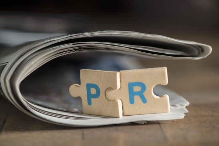 PR letters on newspaper